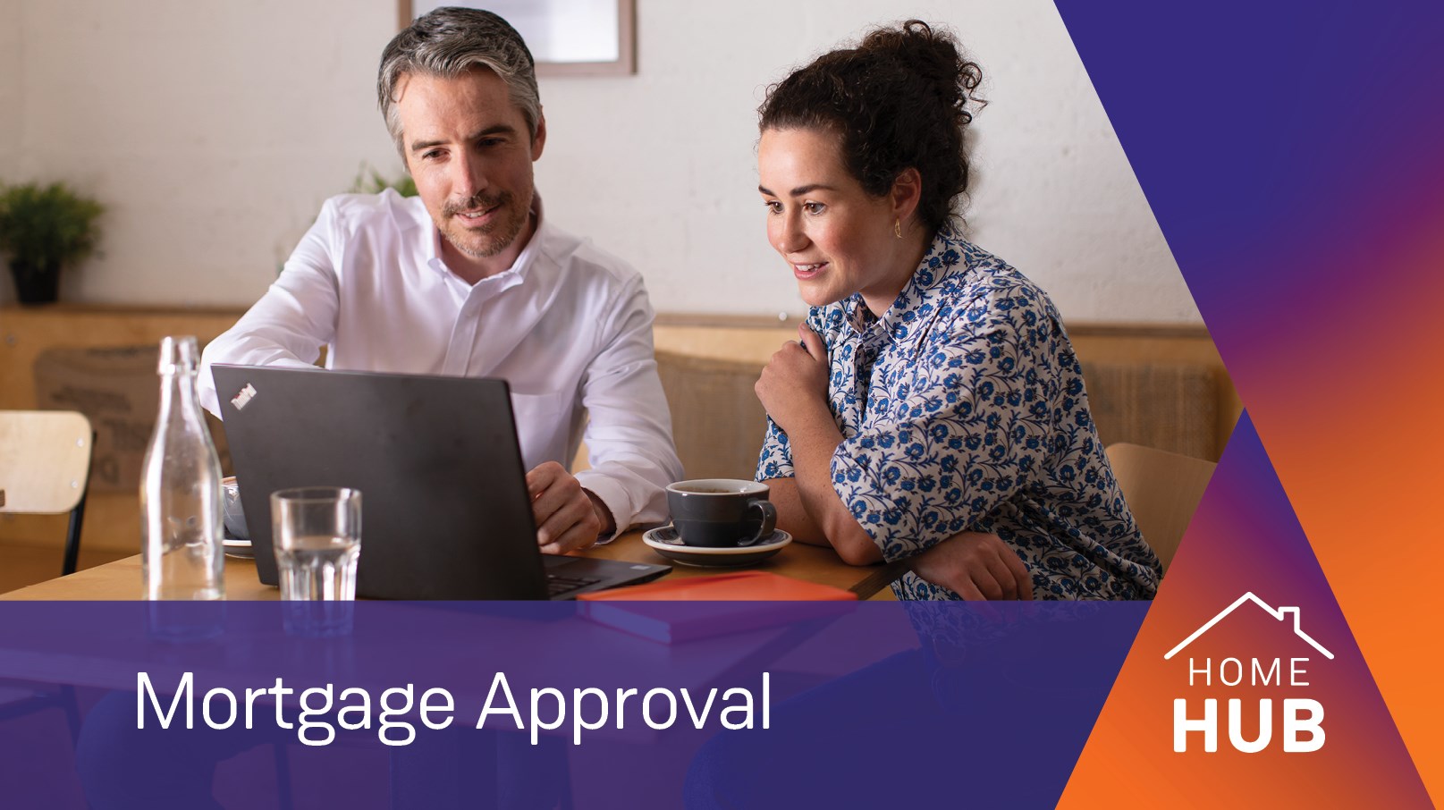 Couple sitting at a table looking at a computer , text over the image 'Mortgage Approval' and 'Home Hub' logo